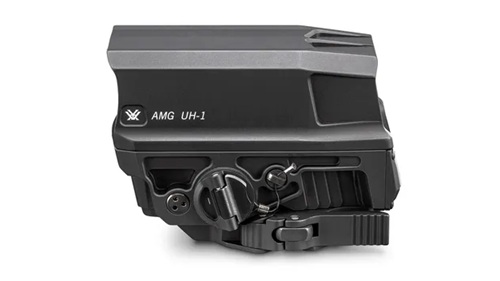 A side view of a Vortex AMG UH-1 holographic sight, featuring a sleek black design with various controls and connectors.